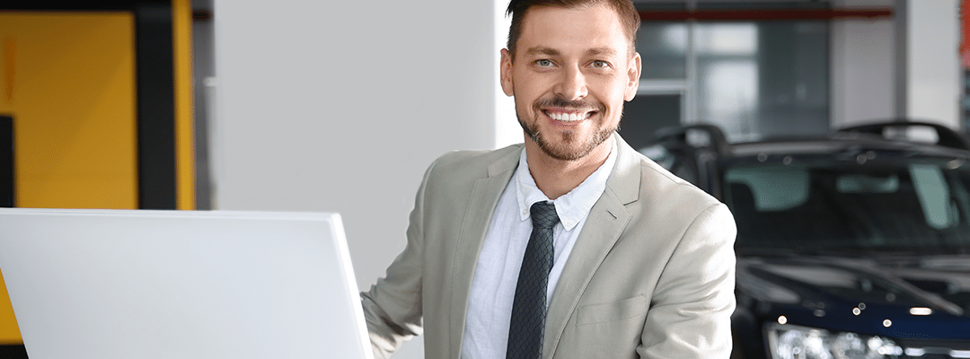 car dealership sales professional working at desk